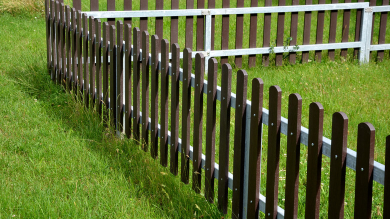 short composite fence in green lawn