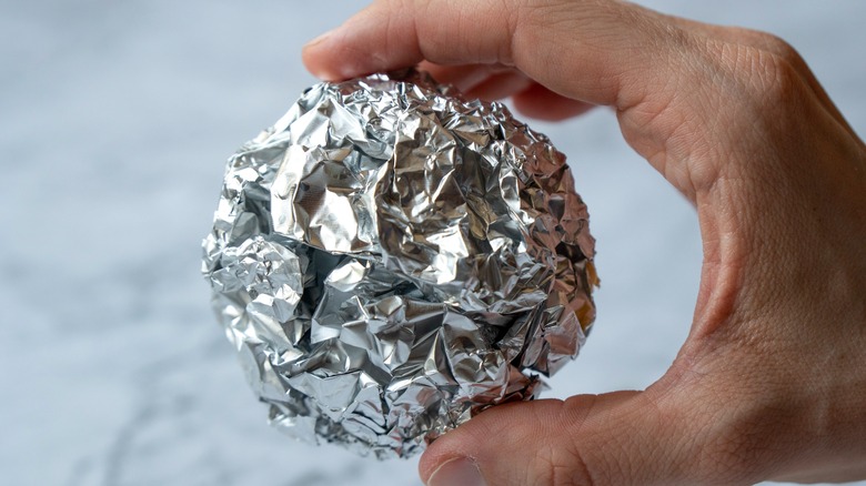 Person with ball of aluminum