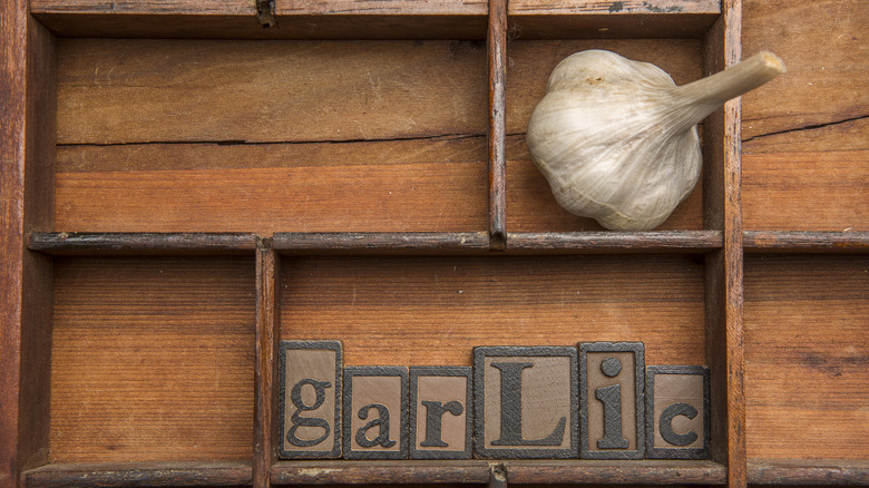 Vintage Wooden typesetting tray with garlic bulb and letters