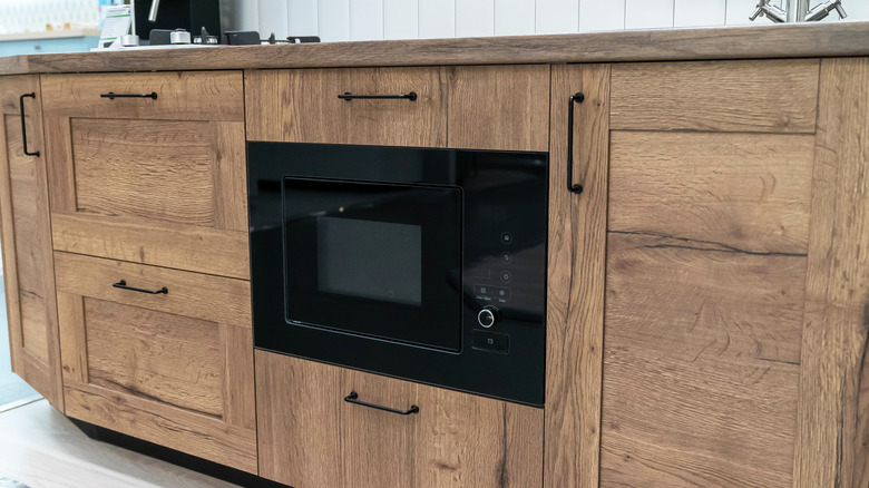 Built-in microwave in wooden cabinetry