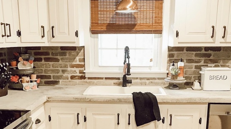 brick backsplash with concrete countertops