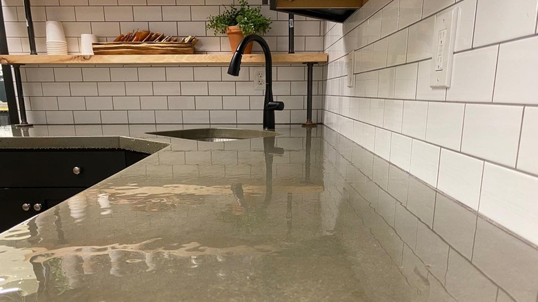 white backsplash with concrete countertops