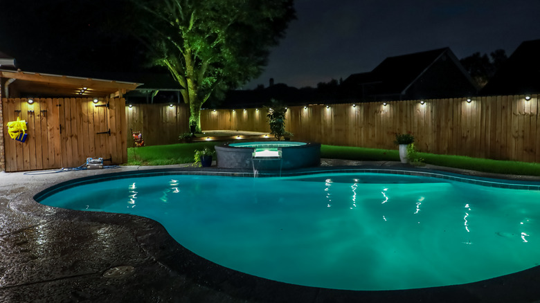 Pool with solar-powered fence lights