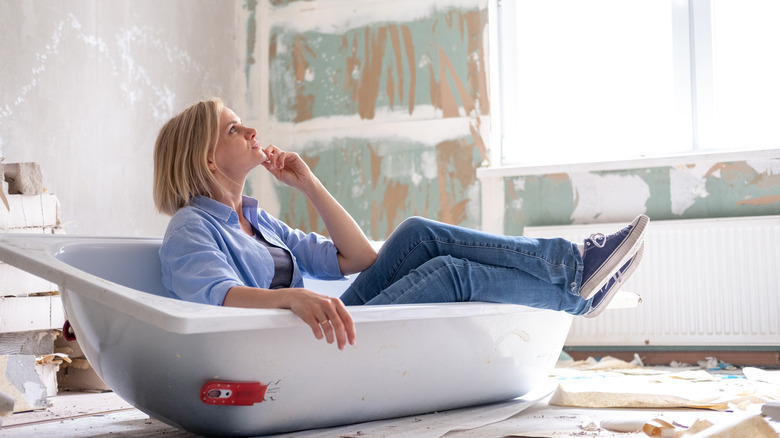 Woman examines bathroom being remodelled