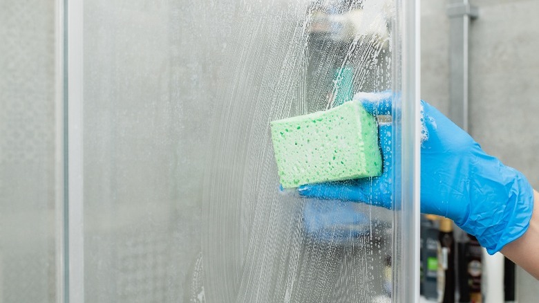 person cleaning hard water stain