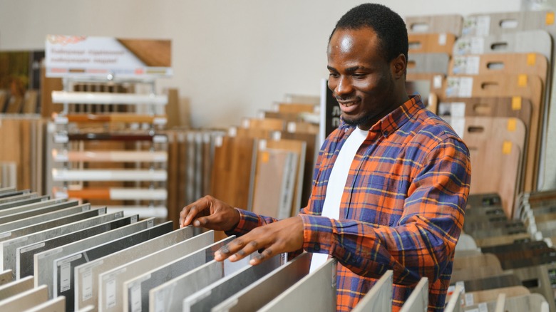 Man looking at floor samples