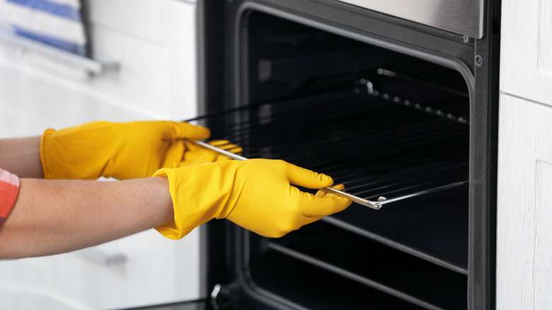 person removing oven rack