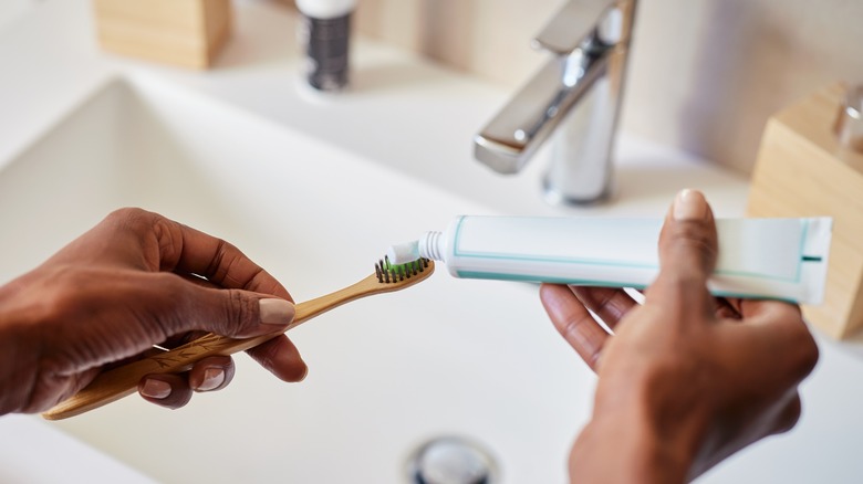 squeezing toothpaste from a tube