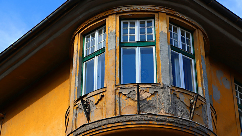 an exterior shot of an old home with bay windows