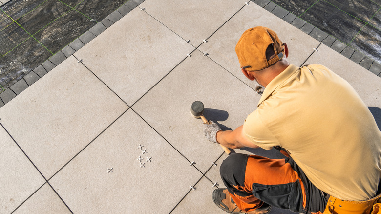 person installing pavers