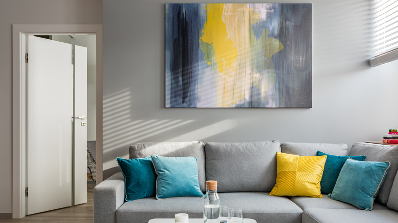 large abstract painting over sofa