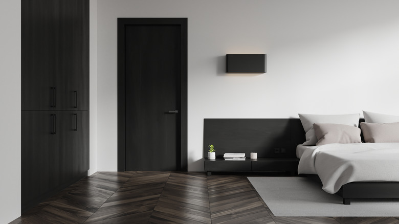 A minimalist bedroom with chic a black door.