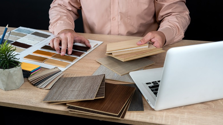 person looking at hardwood floor samples