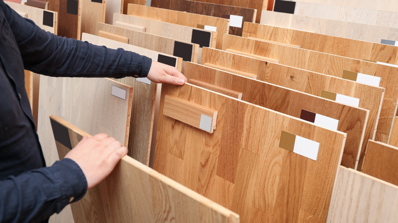 Person looking through hardwood flooring samples