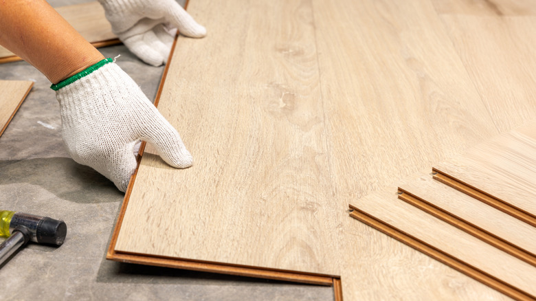 A person installing wooden flooring.