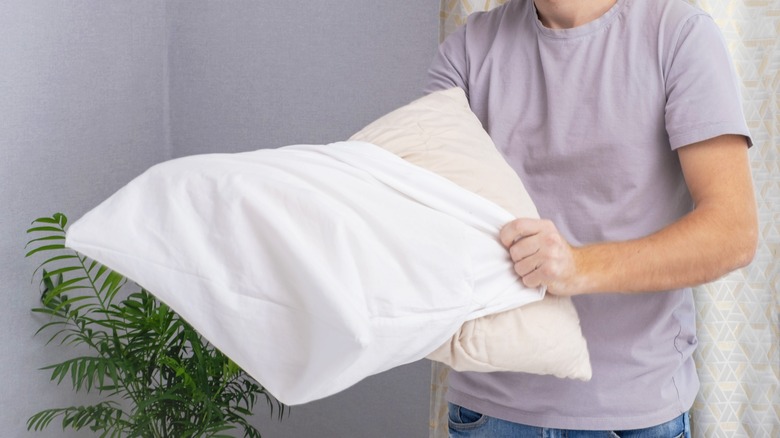 putting on a pillowcase