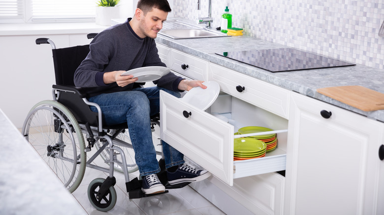 Person pulling plates from drawers