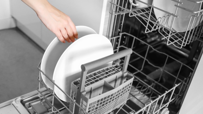 Hand loading the dishwasher