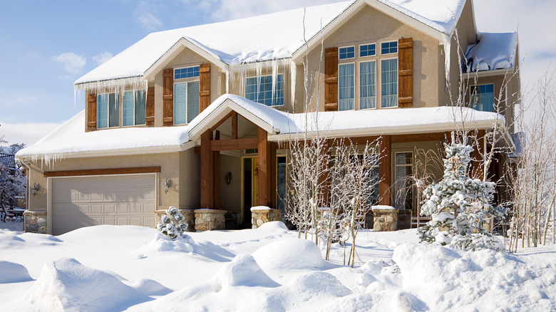 Snow covered lawn in front of a house