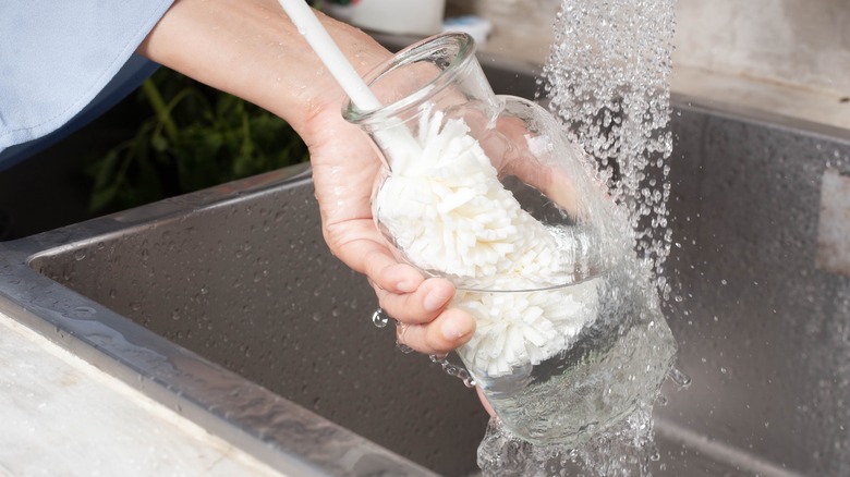 cleaning vase in sink