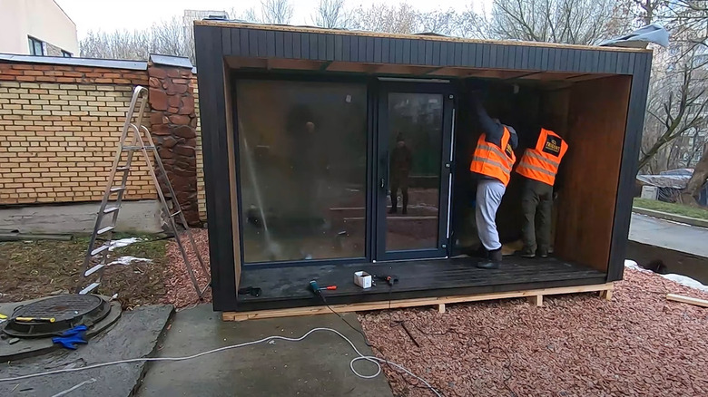 men assembling garden house