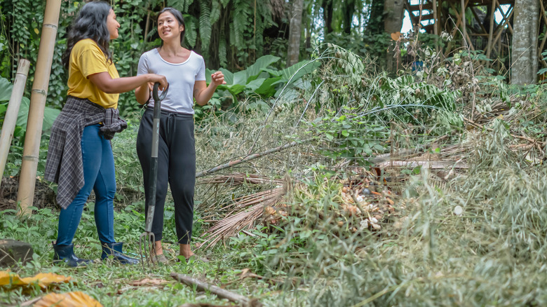 Women building brush pile