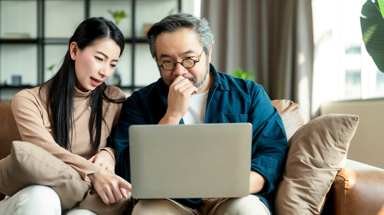 couple sharing laptop screen