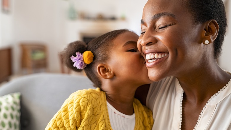 child kissing mother's cheek 