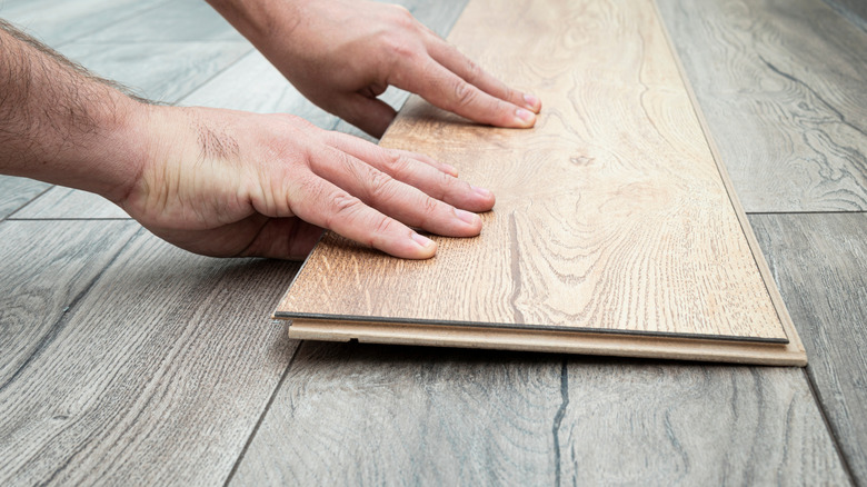 Man comparing new floor over old floor