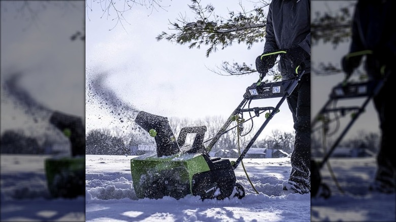 A person using the Earthwise Snow Blower on a sidewalk