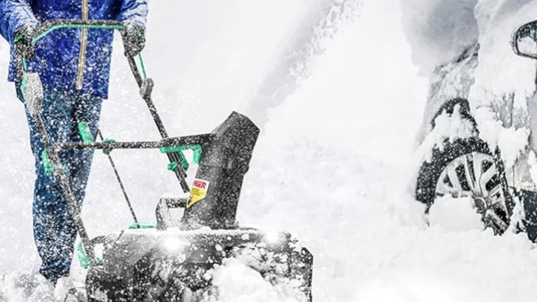 A person in blue jacket using the Litheli Snow Blower