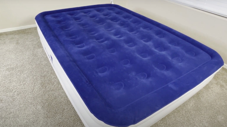 blue air mattress on floor
