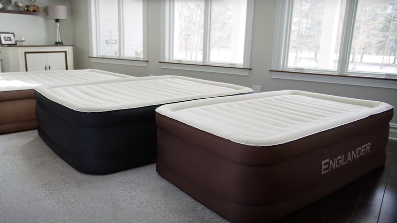 three air mattresses in bedroom