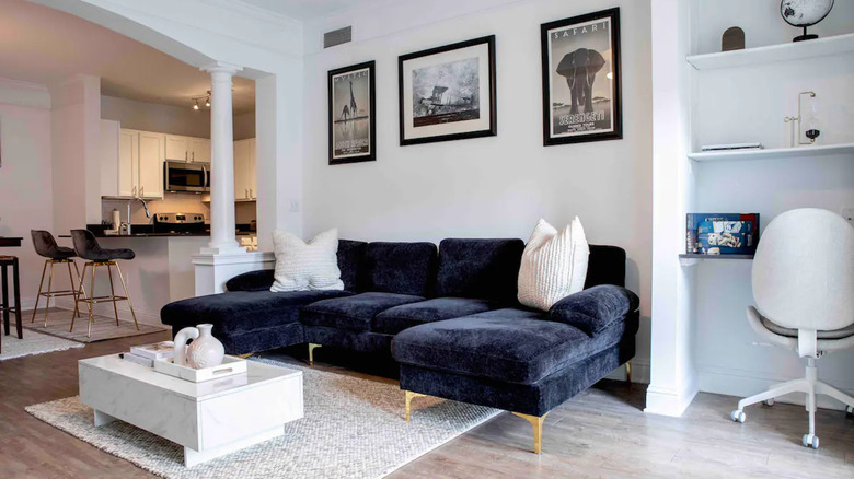 navy blue couch in white room