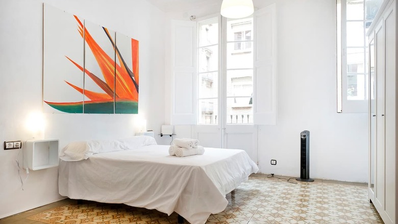 white bedroom with orange painting