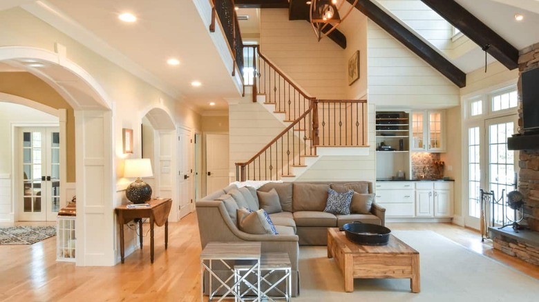 neutral living room with tall ceilings 