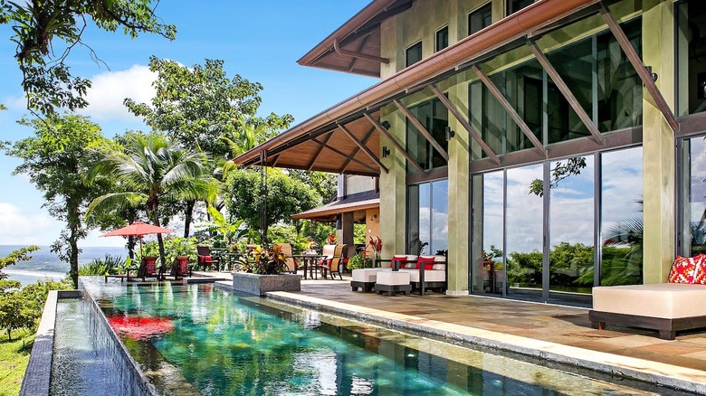 two story house with pool and deck