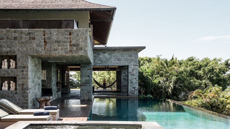 stone villa with hammock and pool