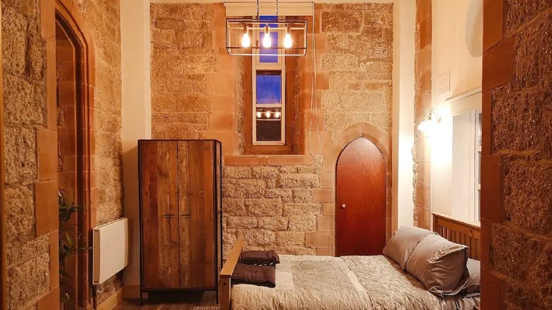 bedroom with stone walls