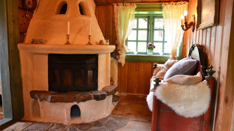 A fireplace and wooden chair in the cabin