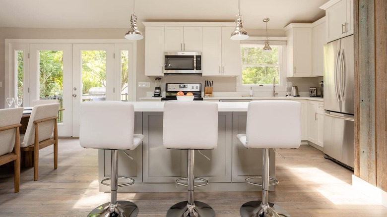 modern white kitchen with bar stools