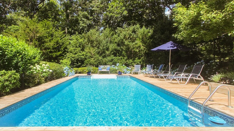 pool with deck and lounge chairs