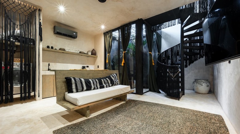 living room with black spiral staircase