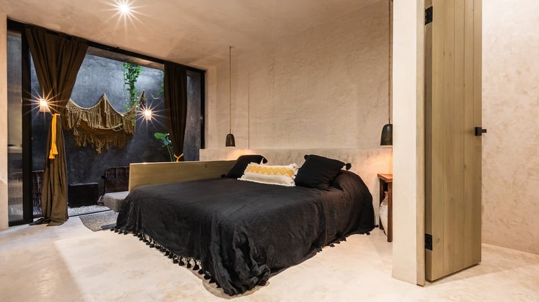 bedroom with black bedding and curtains