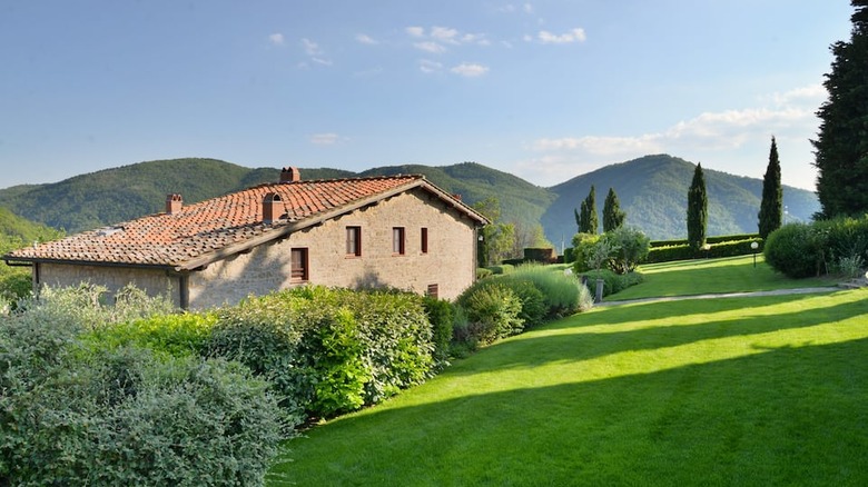 brick villa surrounded by green grass