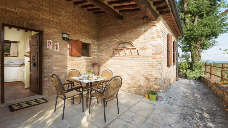outdoor dining table and brick exterior 