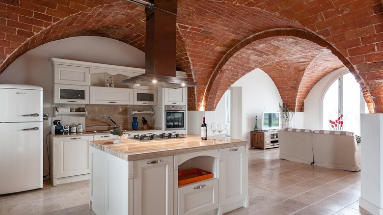 white kitchen with brick ceiling 