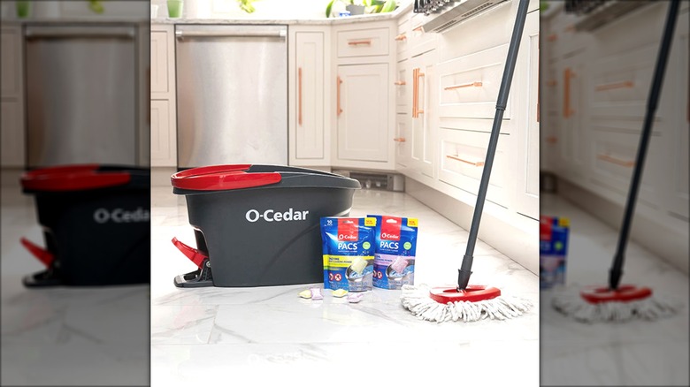 An O-Cedar Easy Wring Spin Mop and Bucket in white kitchen