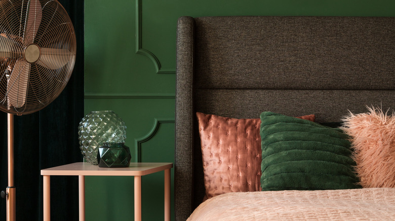 Green bedroom with pink bedding