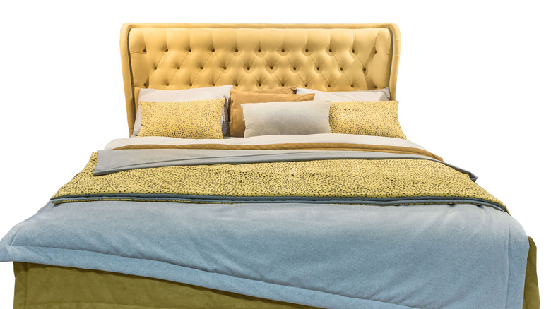 yellow bed with linens